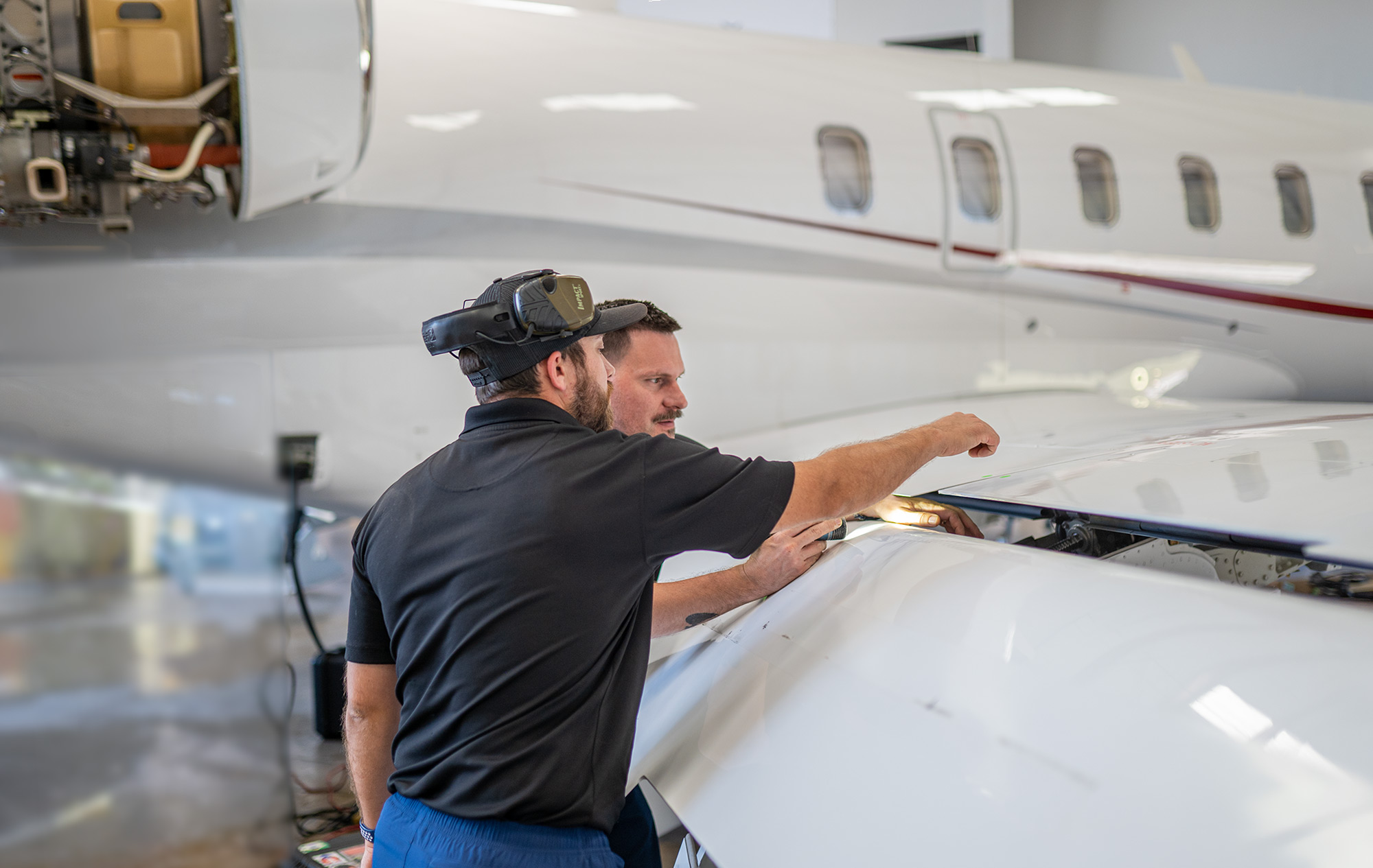 Wing inspection in progress on a Bombardier Challenger at Plane Place Aviation